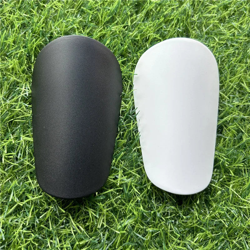 Black and white extra small plastic football shin guards for junior players