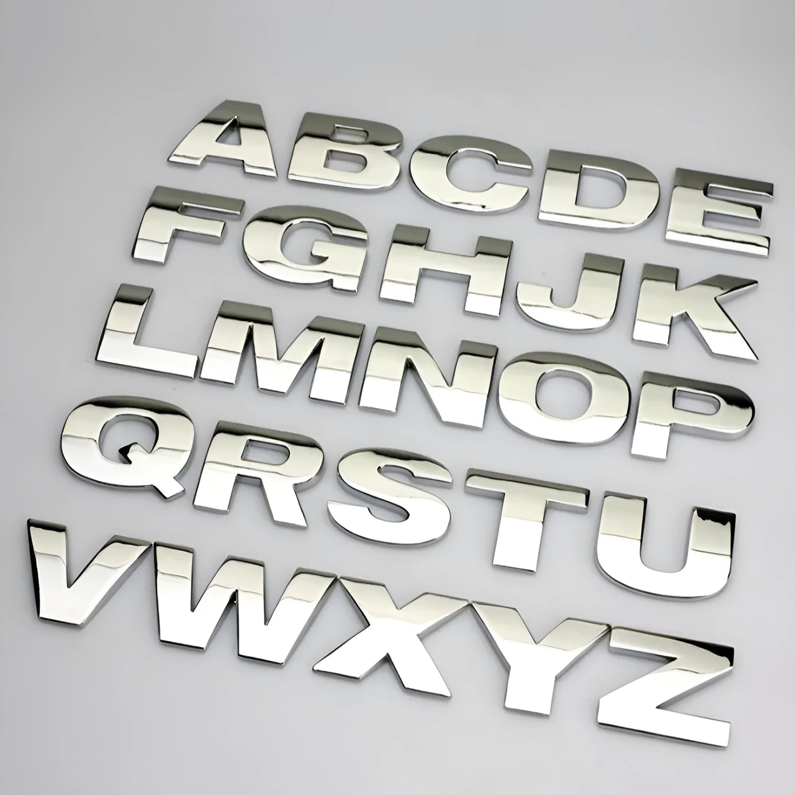 Close-up of a 3D metal zinc alloy car letter sticker in silver, showing its raised profile.