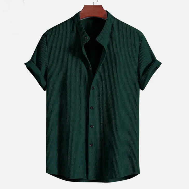 Men's loose fit short sleeve casual shirt in light blue, hanging on a plain background.