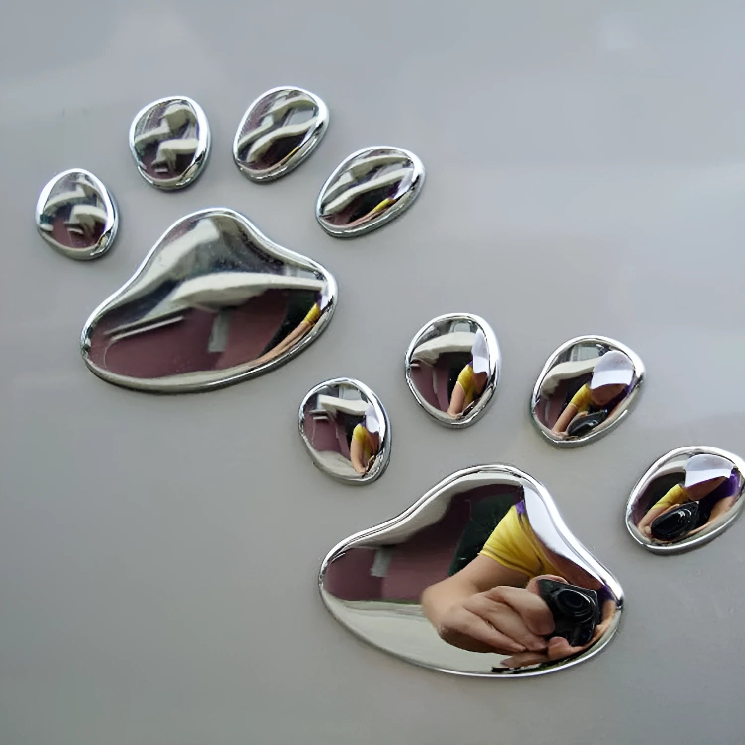 PVC hand-shaped car sticker with dog footprints in red, silver, gold, and black colour options.