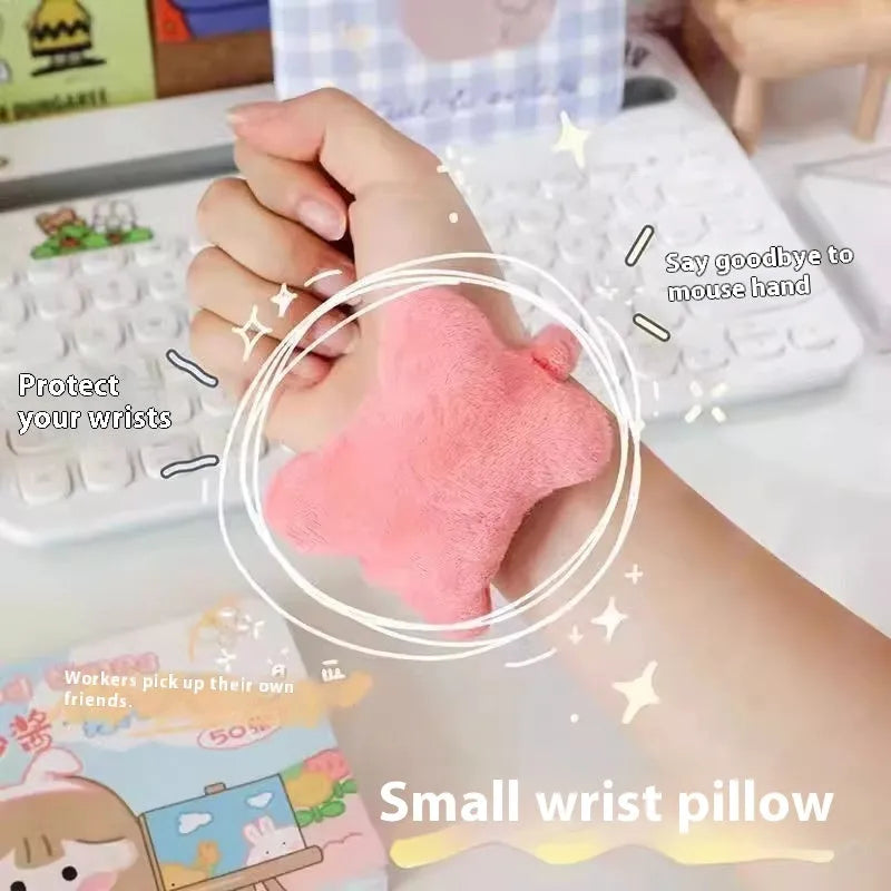 Plush wrist protector mouse pad in blue, green, and pink colours on a desk.