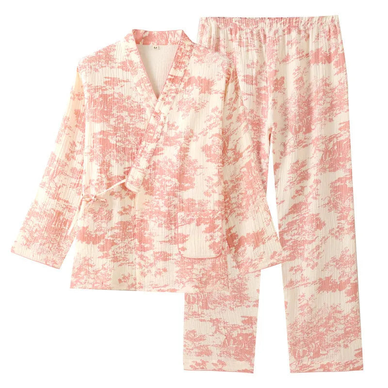 Women's pink cotton gauze lounge suit set with lace-up long sleeve top and matching trousers on a hanger.