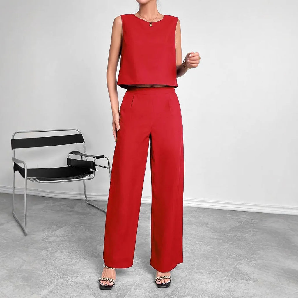 Red polyester women's two-piece set with sleeveless top and wide-leg trousers laid flat.