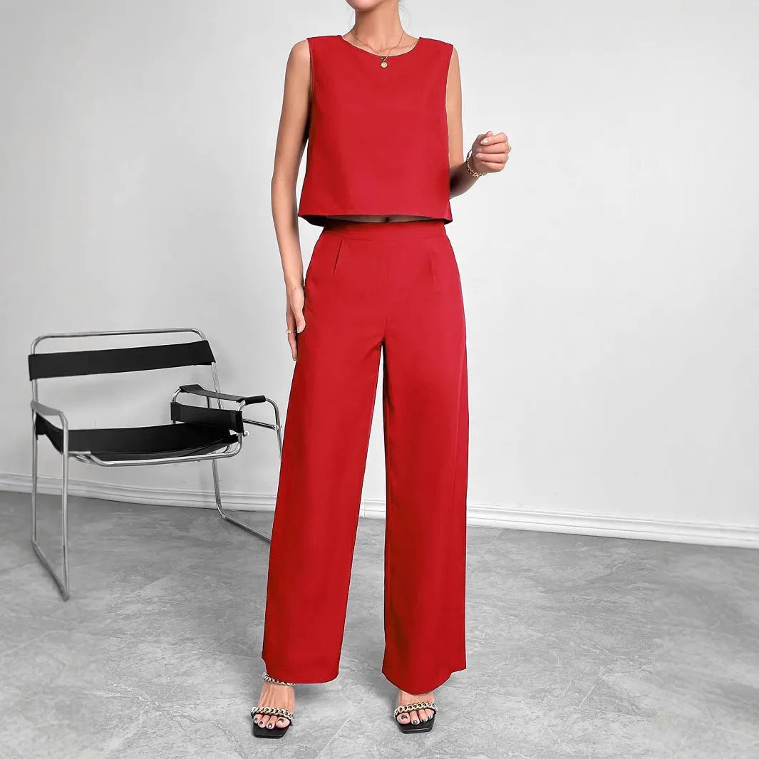 Red polyester women's two-piece set with sleeveless top and wide-leg trousers laid flat.