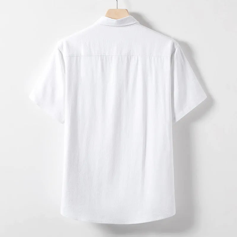 Man wearing a solid colour linen T-shirt with loose lapels and short sleeves.