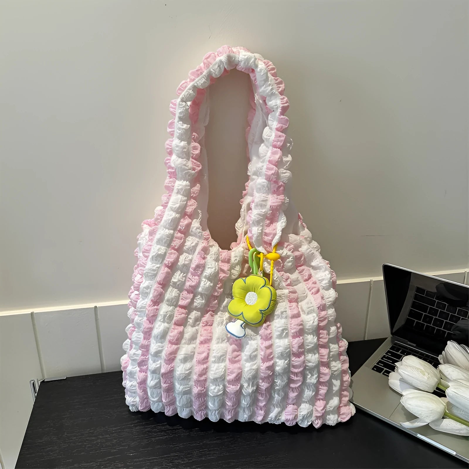 Soft pleated square bubble bag in beige with a removable pendant and single shoulder strap.