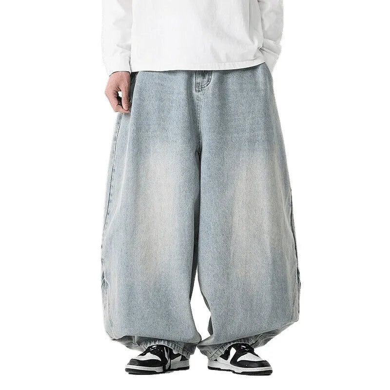 Men's plus-size baggy blue denim jeans with straight leg and low waist on a neutral background.