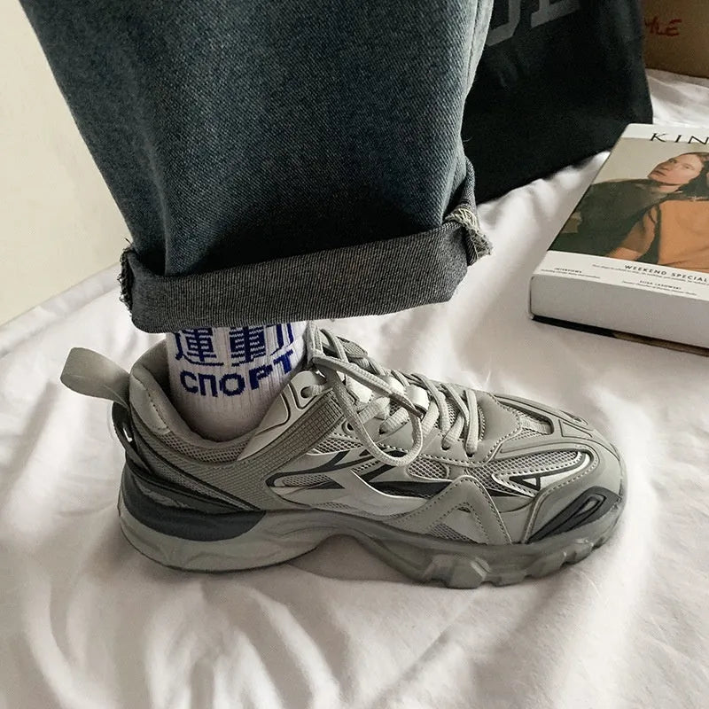 A pair of casual solid-colour sports shoes with a round toe and lace-up closure, shown in one of the available colours.