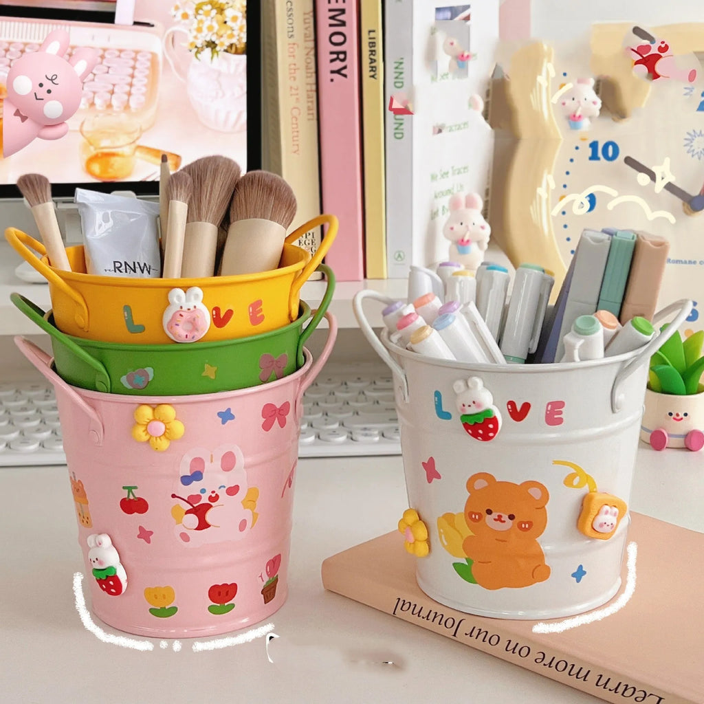 Round metal pen holder for desktop organisation, shown in available colour options including green, pink, and red.