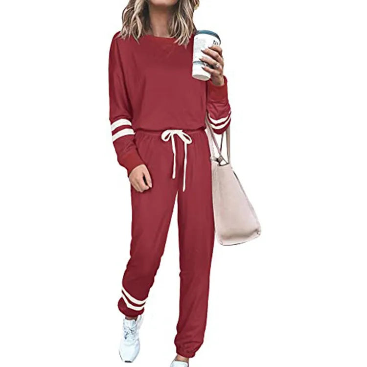 Women's loose-fitting casual suit in solid colour, showing long sleeve top and trousers in cotton blend fabric.