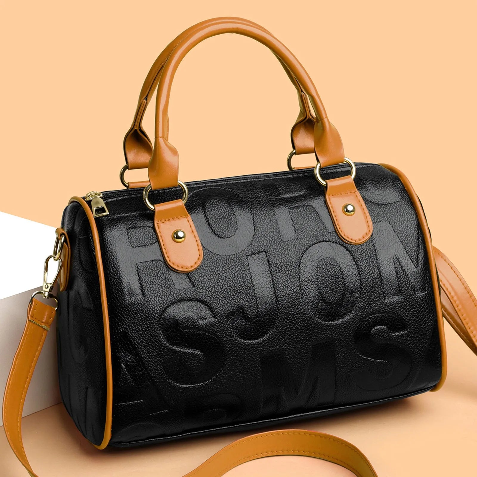 Cylindrical PU crossbody bag with three shoulder straps in red or brown colour with polyester lining