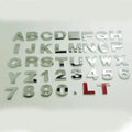 Close-up of a 3D metal zinc alloy car letter sticker in silver, showing its raised profile.