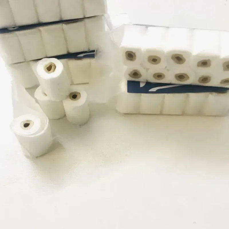 Miniature simulated toilet paper roll model made from paper for dollhouse and children's pretend play.