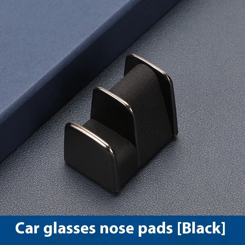 Zinc alloy and leather car dashboard clip for holding sunglasses, shown in green.