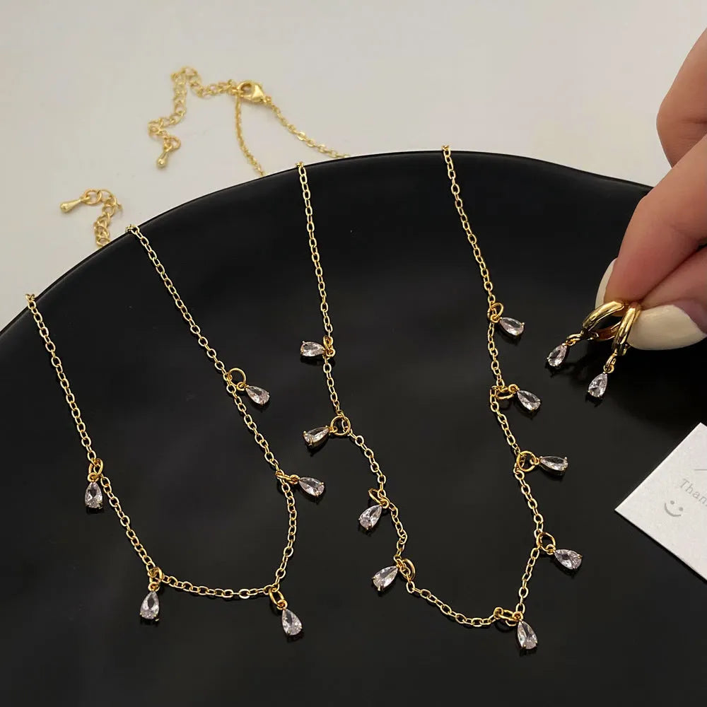 Three-piece zircon jewellery set for women showing necklace, earrings, and anklet with geometric meteor shower design.