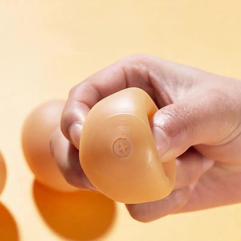 Natural rubber egg-shaped dog chew toy with a squeaker inside for dental play.