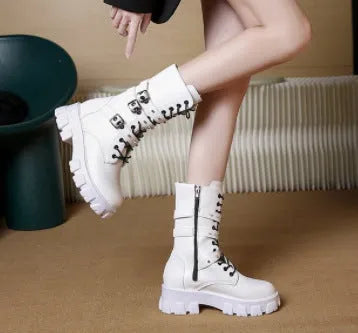 Black mid-calf women's boots with a large metal buckle and side zip on a white background.