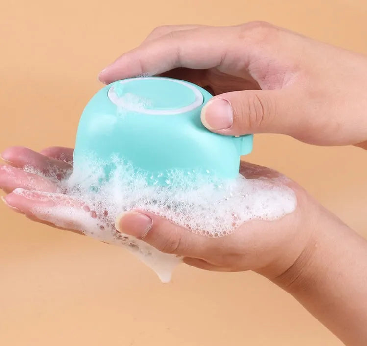 Silicone dog bath brush in blue, pink and yellow colours with soft rubber bristles and ergonomic handle