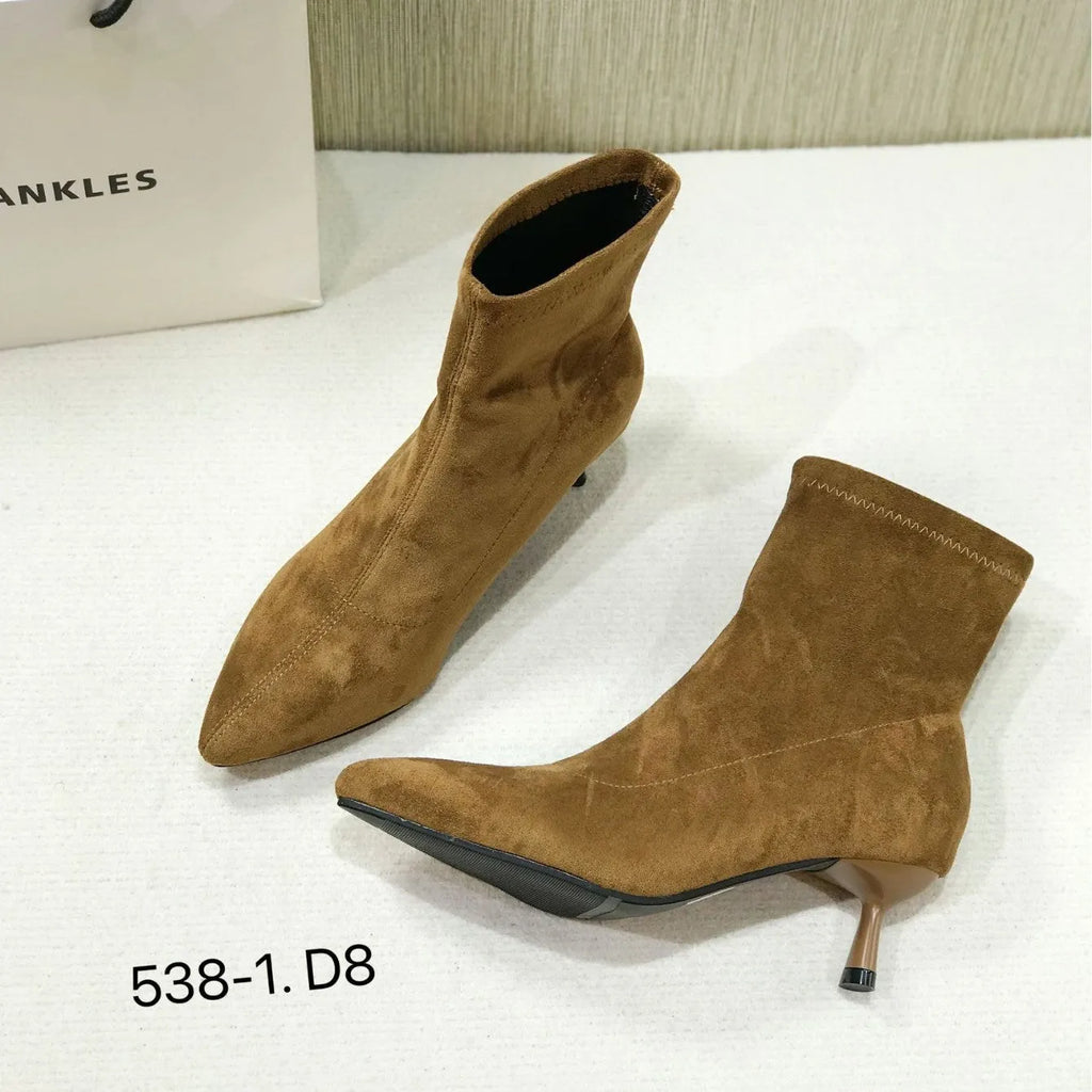 Women's black pointed-toe ankle boots with a stiletto heel and mid-calf sock length.