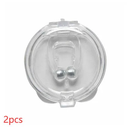 Mini magnetic silicone anti-snoring nose clip in white on a transparent plastic box