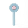 Blue and yellow pet grooming brush with angled bristles and self-cleaning button