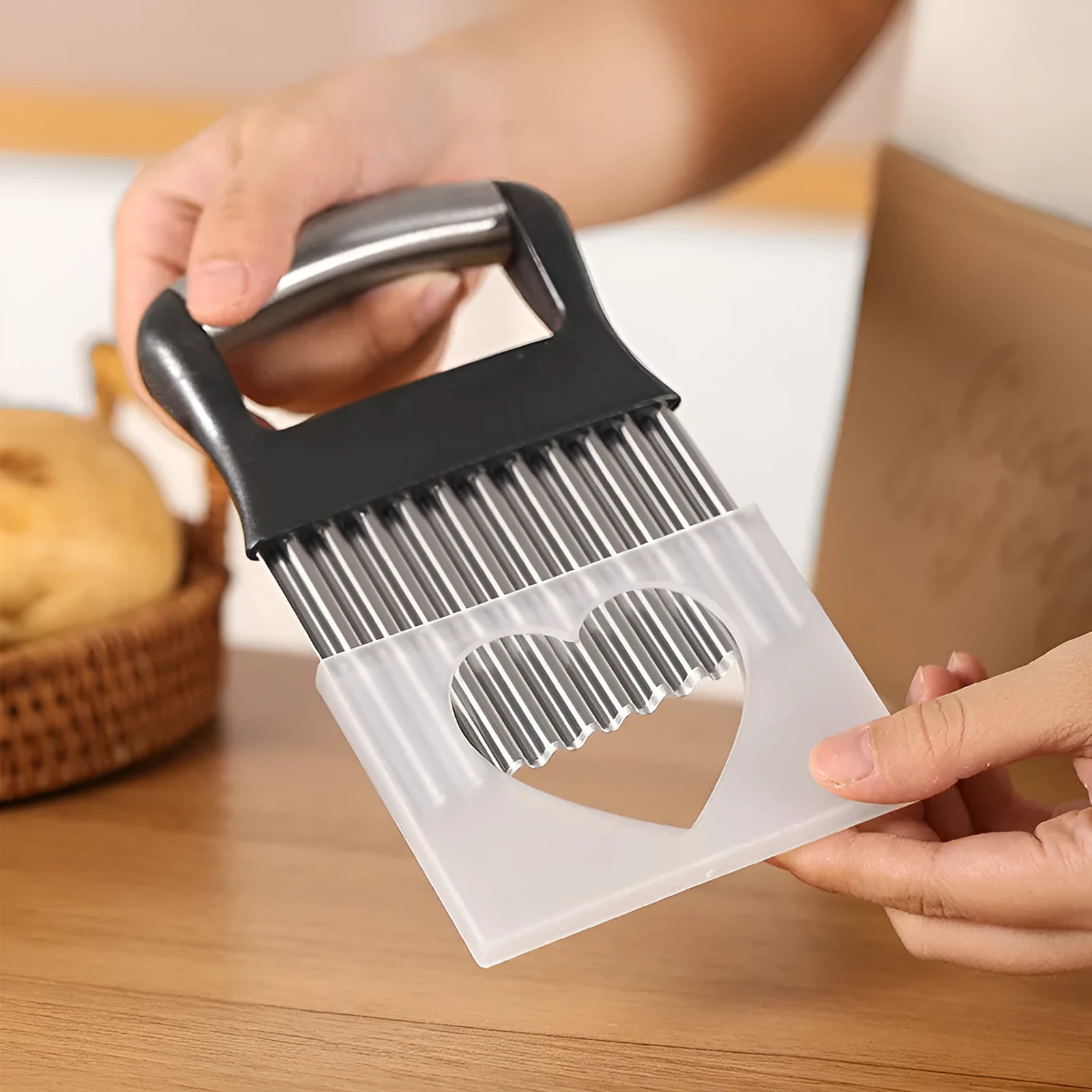 Stainless steel potato wave crinkle cutter knife on a kitchen worktop.