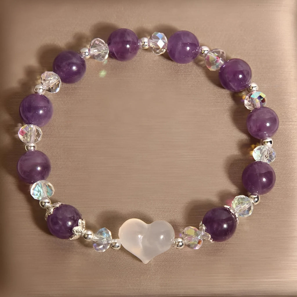Natural amethyst bracelet with white agate love heart charm on a light background