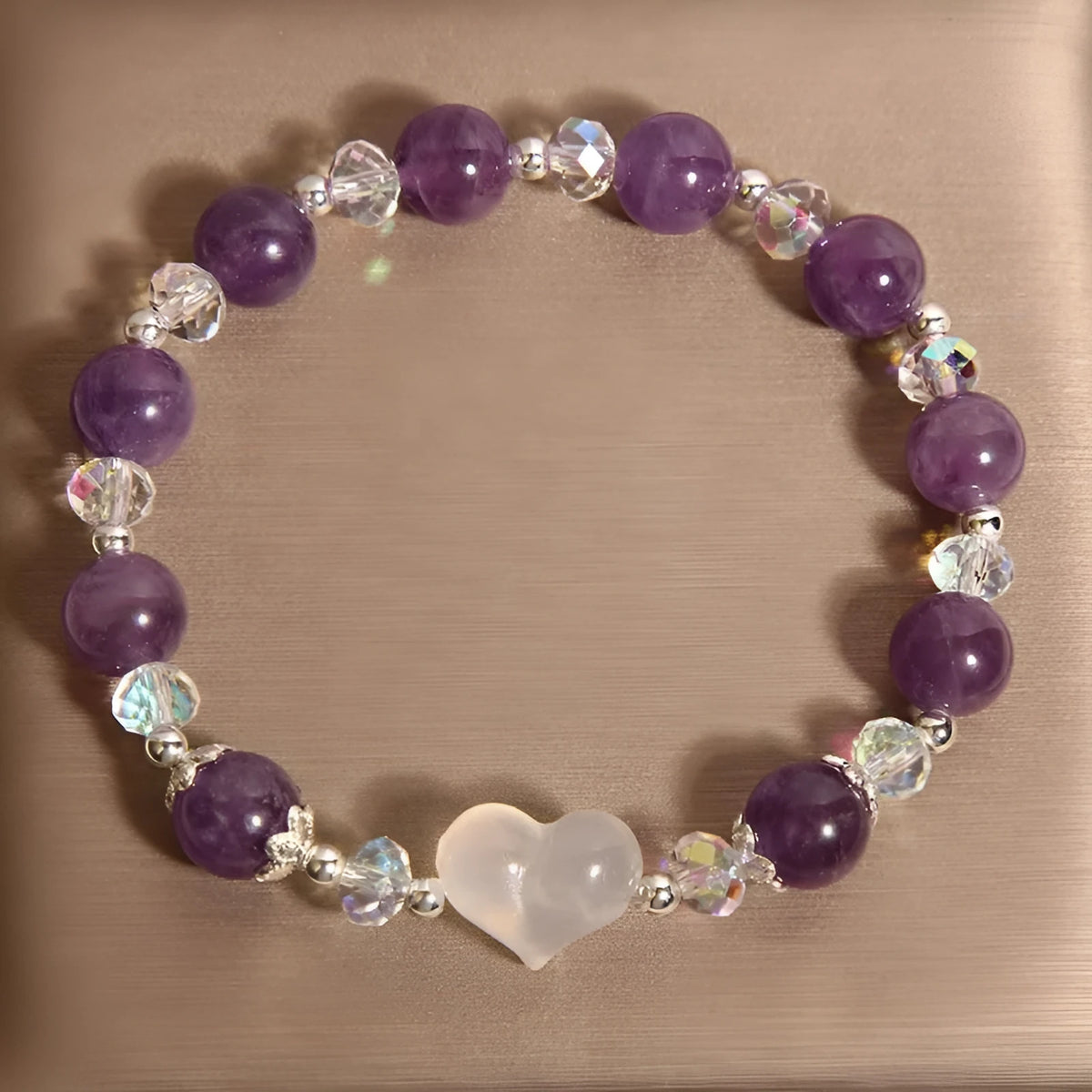 Natural amethyst bracelet with white agate love heart charm on a light background