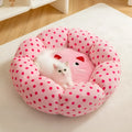 Pink dotted fabric cat bed shown in two circular sizes: 45cm and 65cm diameter.