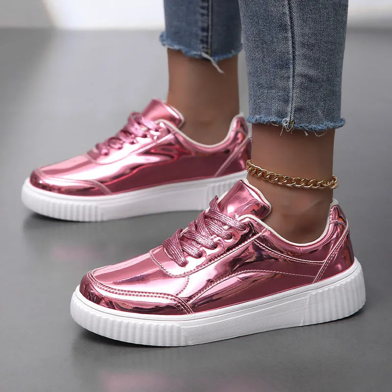 Gold sequinned platform sneakers with round toe and thick MD sole on white background.