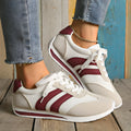 Wine red Cortez Retro sneaker with mesh upper, cross strap, and flat rubber sole.