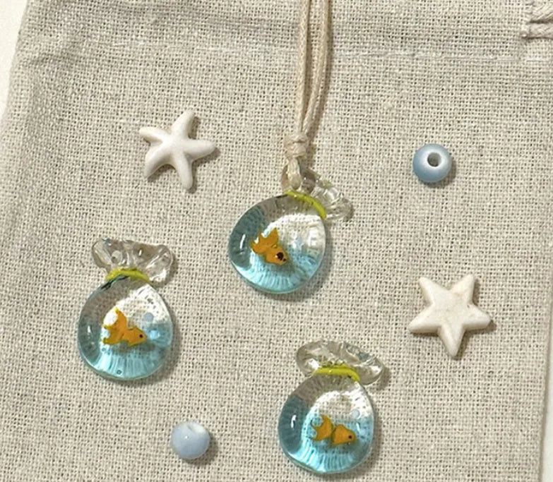 Women's pendant necklace with coloured glaze charm on a cotton and linen clavicle chain in Small Fish Lucky Bag colour.