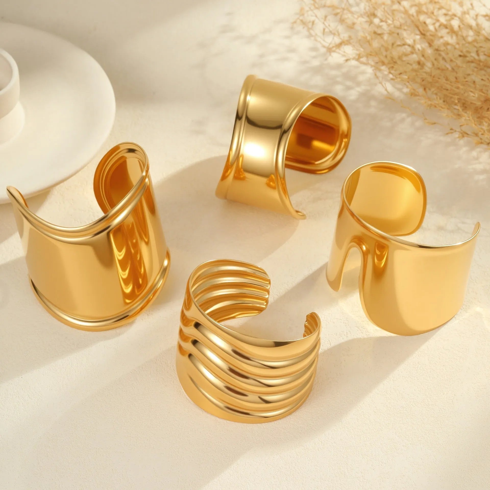 Women's wide fashion bracelet with geometric wave design in gold plating on stainless steel