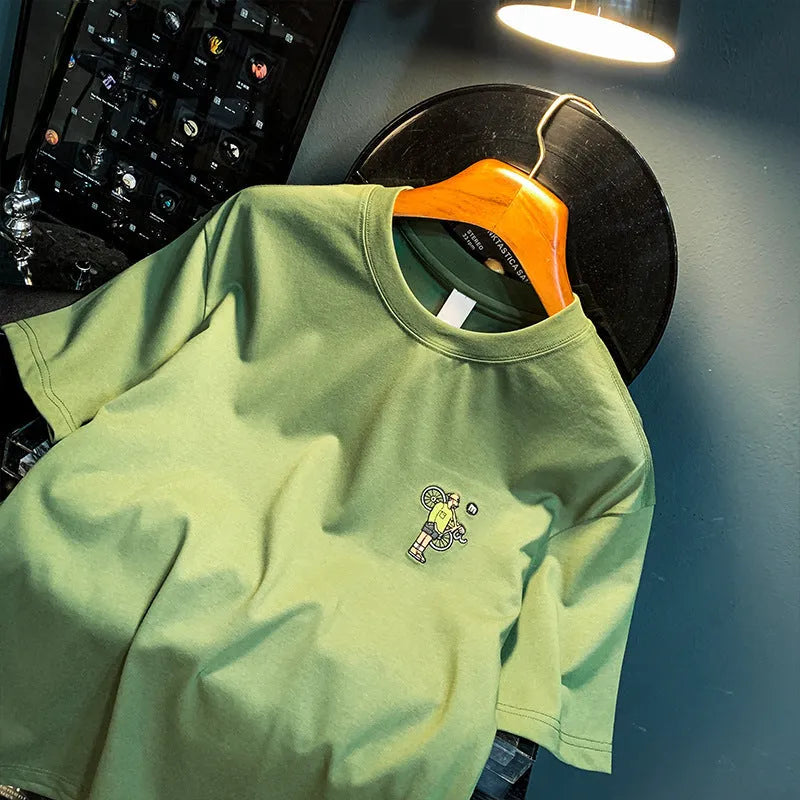 Green men's loose fit T-shirt with a printed literary youth design on the front.