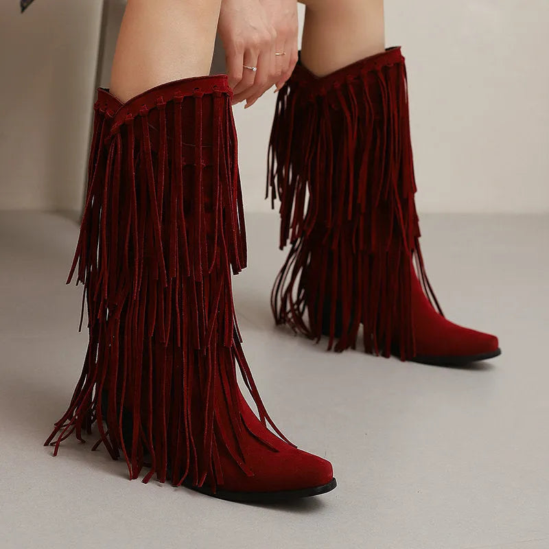 Women's brown suede knee-high boots with tassels and a chunky waterproof platform sole.
