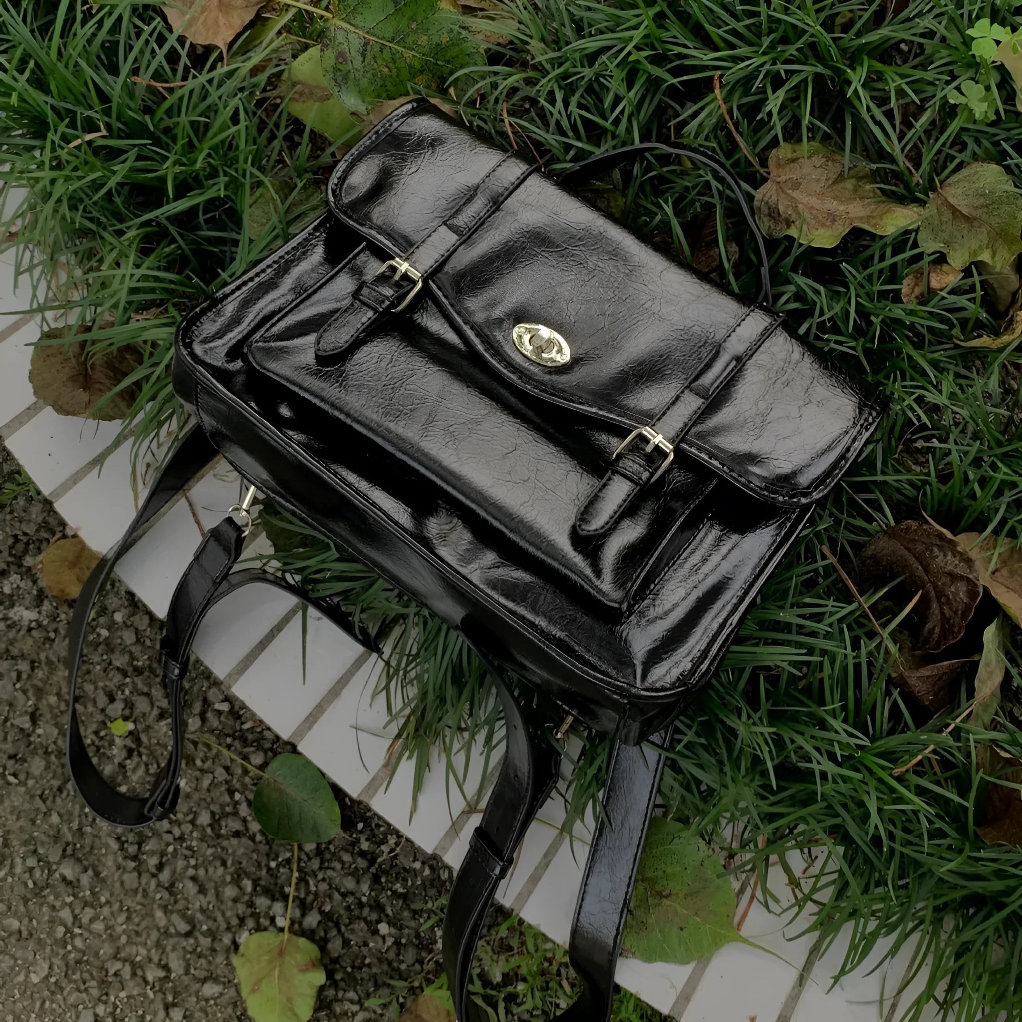 Black college style messenger bag with oil wax leather finish and 35cm length dimensions