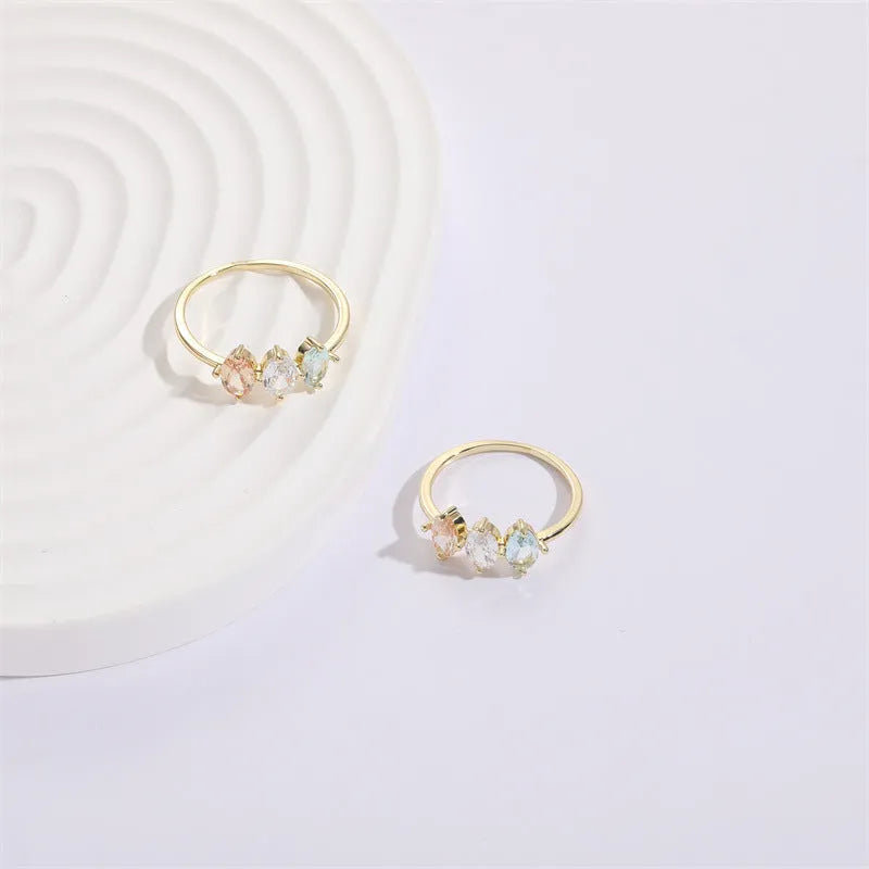 Geometric copper ring with a horse eye motif and tricolour zircon stone, electroplated in 14K Real Gold RG9066 colour.