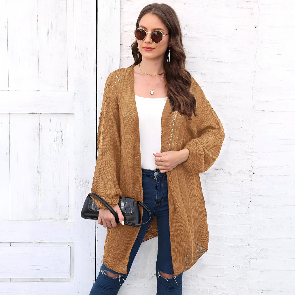 Loose-fitting women's acrylic sweater coat in a solid colour, shown on a model.