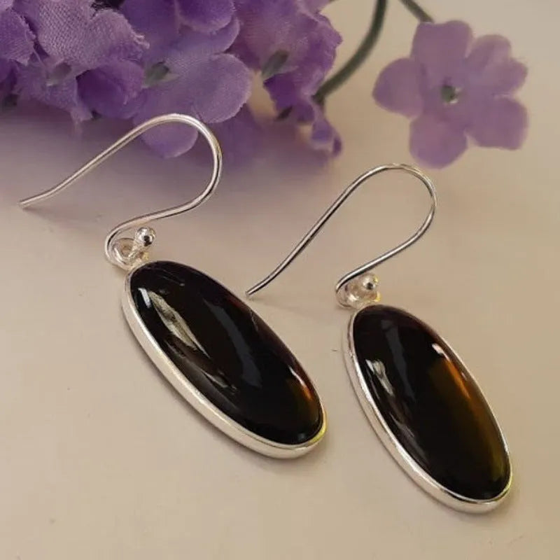 Women's geometric drop earrings with oval black agate pendant in silver setting