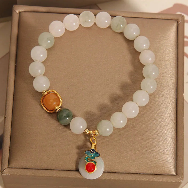 Women's ice jade crystal bracelet with Xiangyun peace buckle and pearl details.