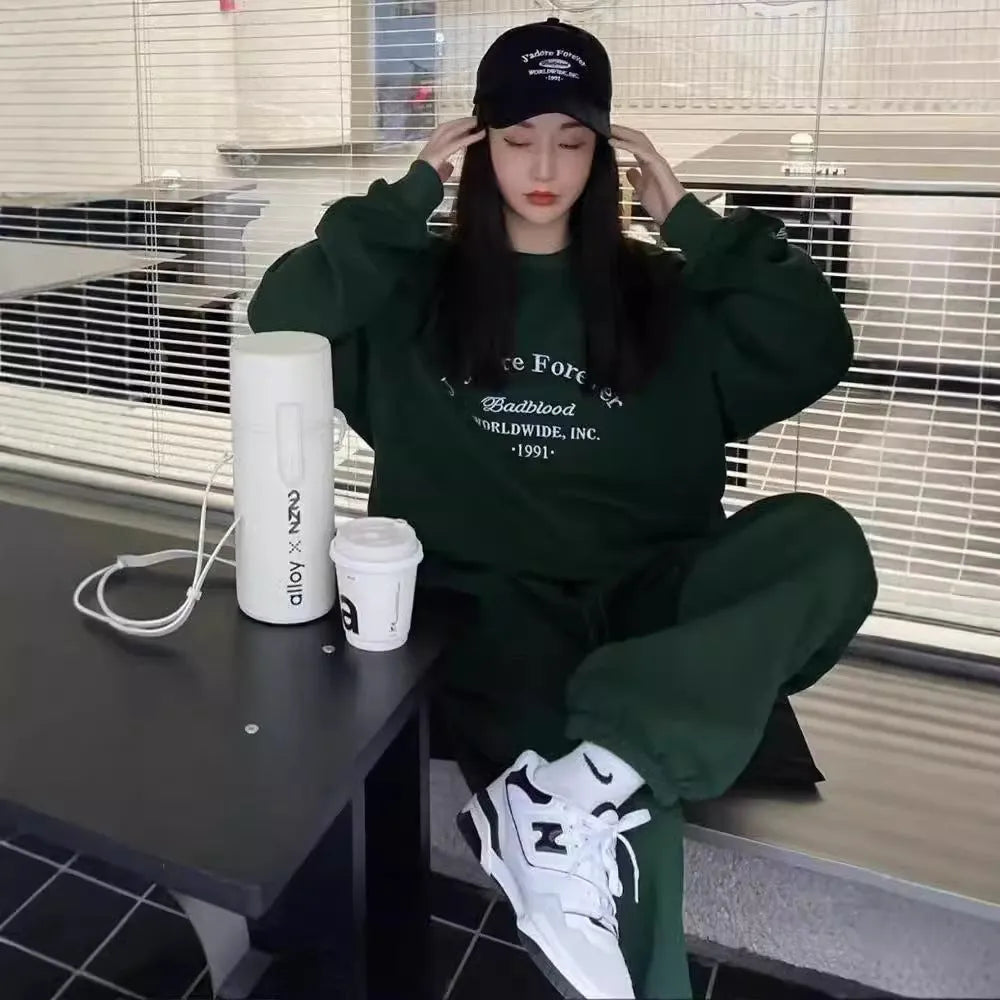 Women's cotton green American-style long-sleeved casual sportswear suit with trousers on a model