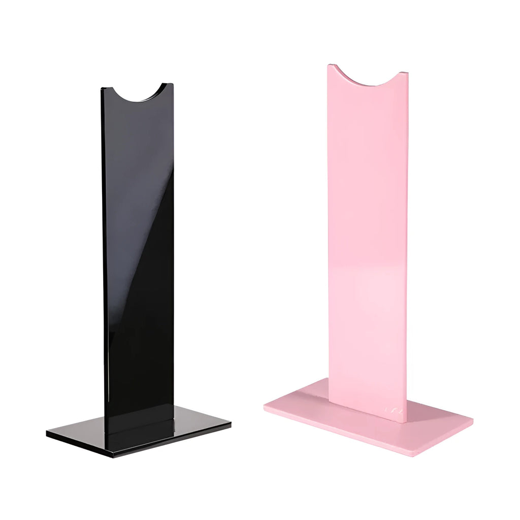 Pink and black detachable headphone stand for gaming headsets on a desk
