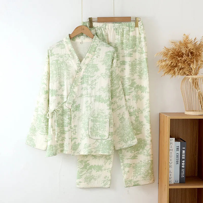 Women's pink cotton gauze lounge suit set with lace-up long sleeve top and matching trousers on a hanger.