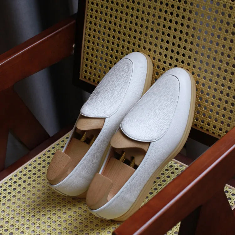 Men's handmade brown leather loafers with a TPR beef tendon sole on a white background.