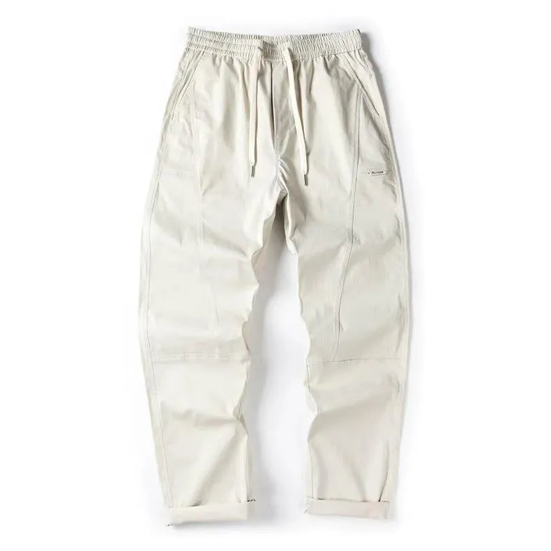 Beige cotton wide-leg casual trousers with elasticated waistband displayed flat