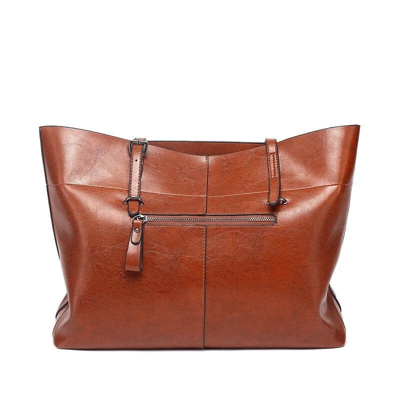 Horizontal wax cowhide leather handbag showing cross-body strap and internal organisation with phone pocket