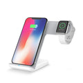 Black and white wireless fast charging pad for mobile phones on a desk