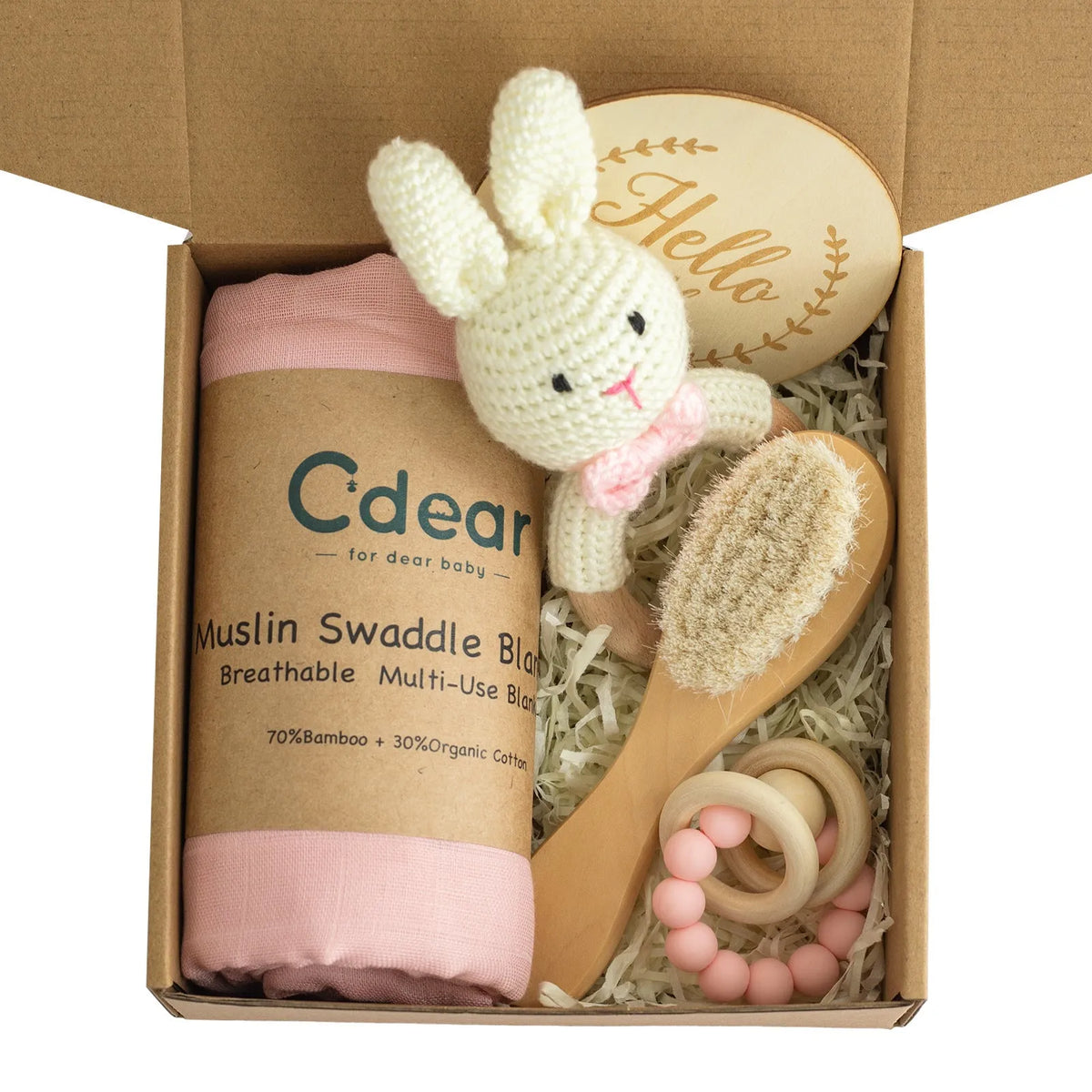 Baby teething toy gift set with bamboo blend gauze blanket, wooden beech bell, teether, brush, and milestone marker.