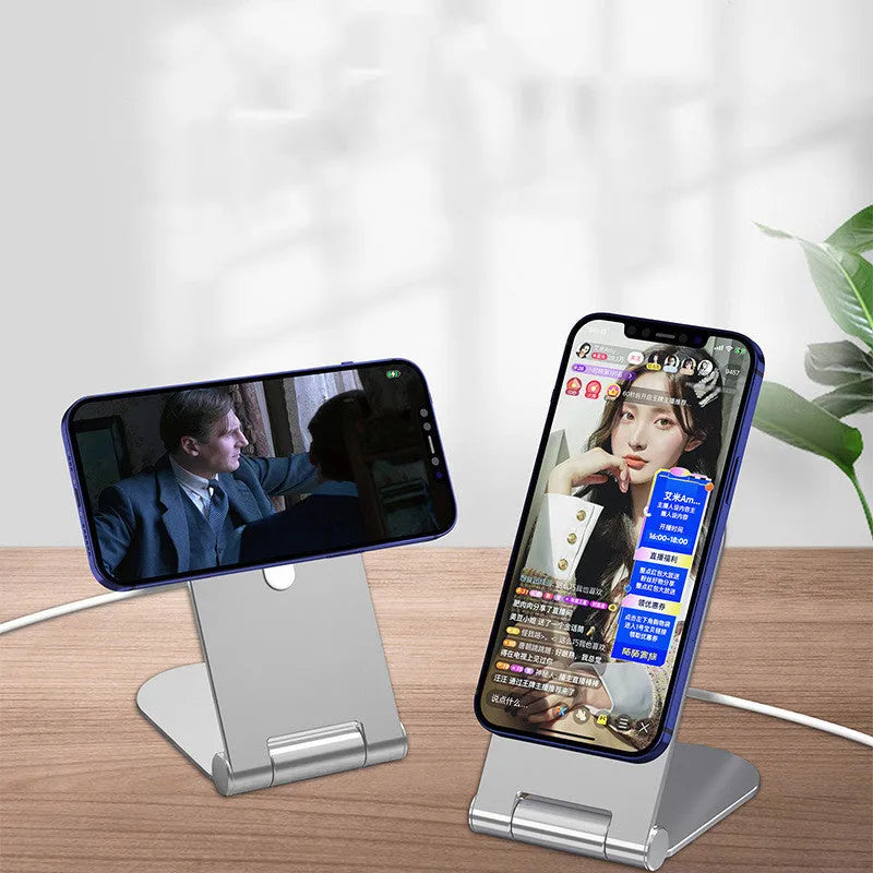 Silver vertical adjustable magnetic phone bracket for iPhone 12 series on a flat surface.