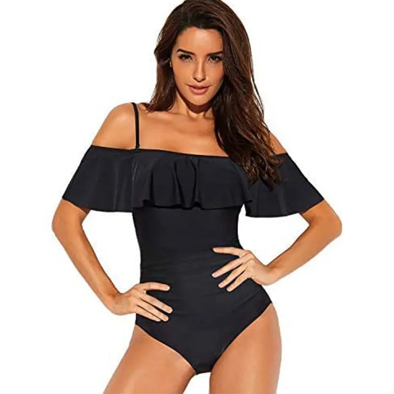 Black one-piece swimsuit with cut-out design and ruffled straps on a tube top.